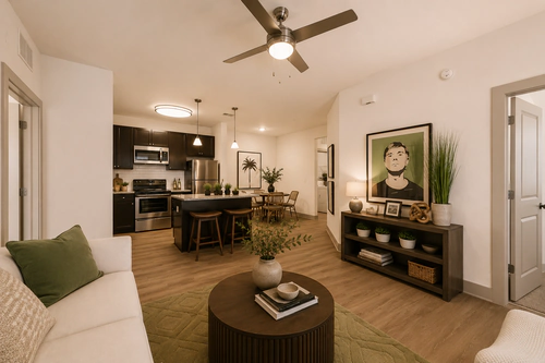 Open living room, kitchen and dining area in a Millennium Apartments home