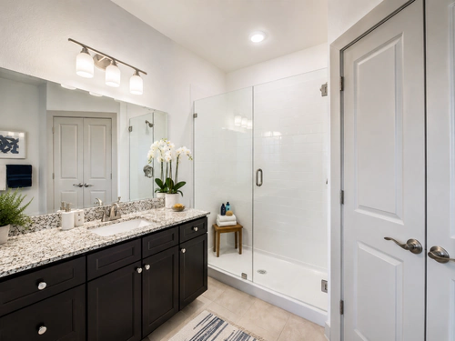 Bathroom with a glass walk-in shower at Millennium Apartments