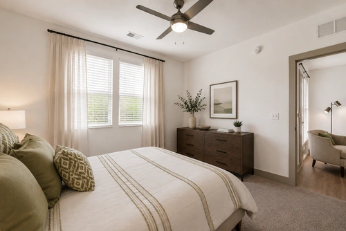Carpeted bedroom in a Millennium Apartments home