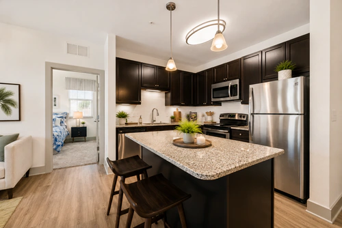 Kitchen island with granite counters at Millennium Apartments