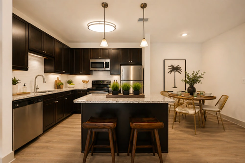 Kitchen and dining area with stainless steel appliances at Millennium Apartments