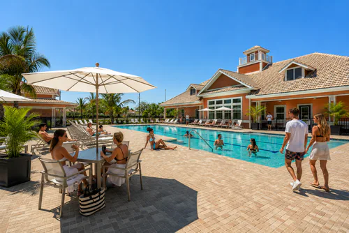 Poolside tables and lounge chairs at Millennium Apartments