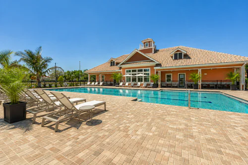 Lounge chairs along Millennium Apartments' pool deck
